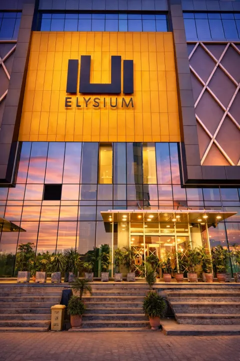 Luxury serviced apartment exterior at Elysium Tower Islamabad with city and mountain views